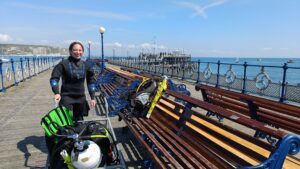 A diver movign their kit on Swanage Pier