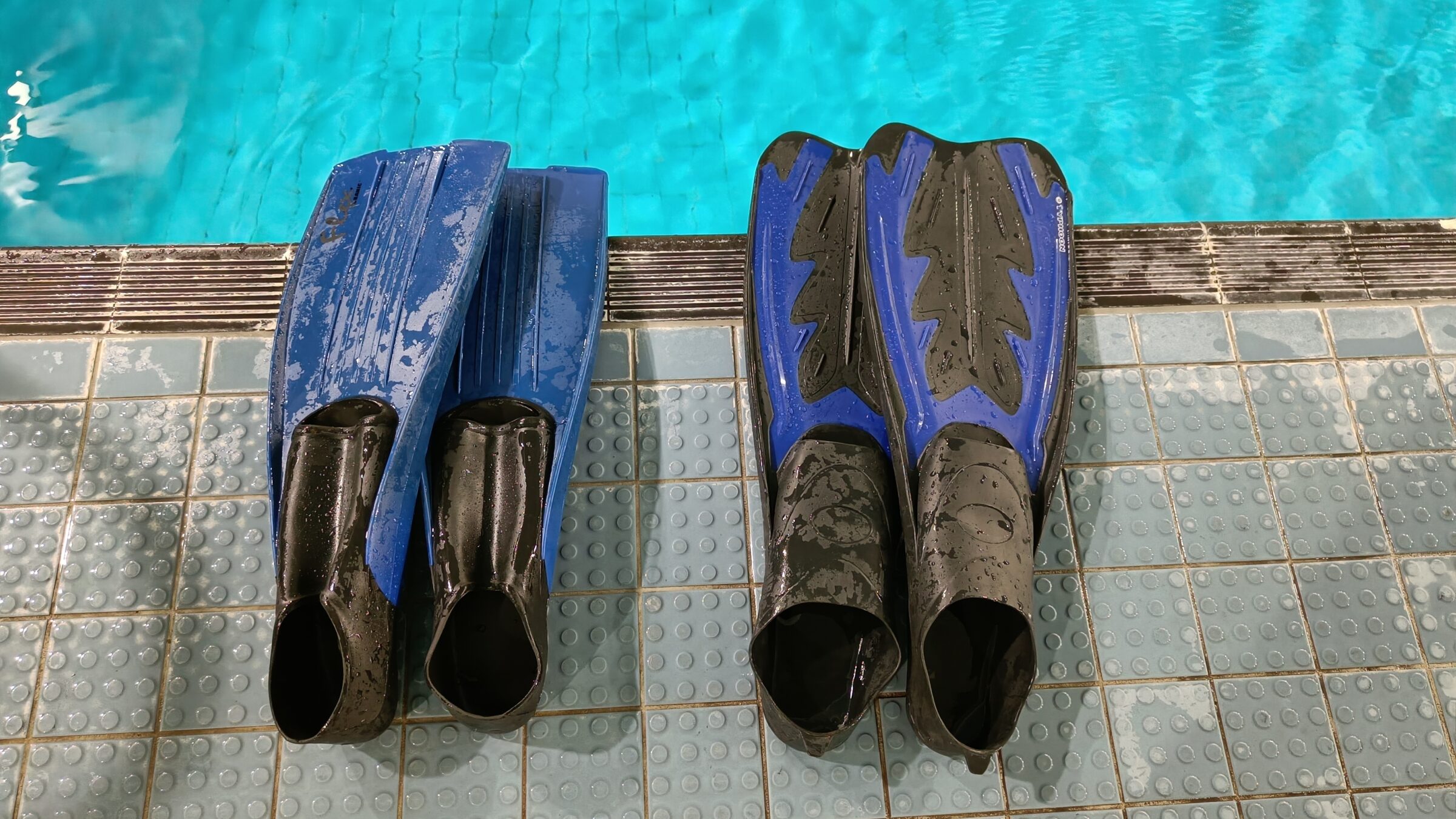 Two pairs of fins ready on the poolside